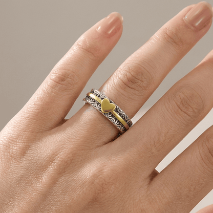 Anillo de banda de oro artesanal con corazón, de la marca Rose & Oliver, mostrando detalles delicados y acabado pulido.
