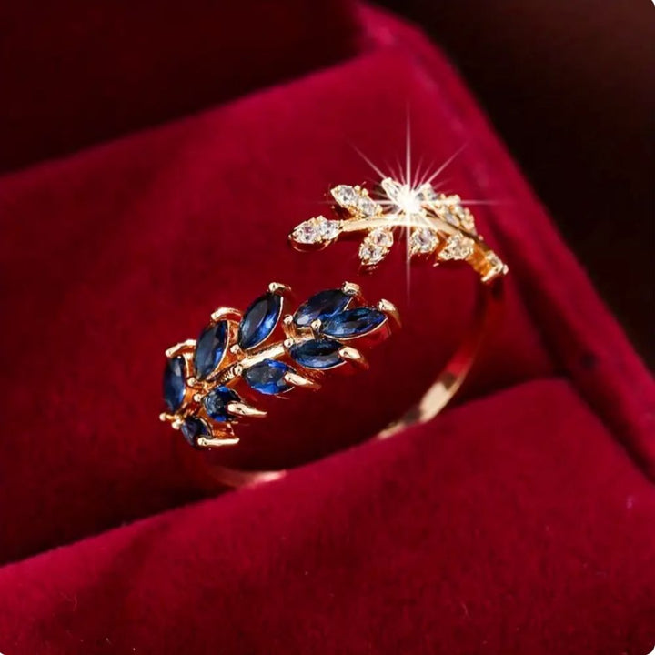 Ring Vivara mit Saphir, goldfarbenes Finish, elegante Details, hergestellt von der Marke Rose & Oliver, Nahaufnahme des Juwels.